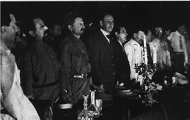 platform at second congress - Sokolnikov (partly visible at left), Serrati, Trotsky, Levi, Zinoviev, Kalinin, ... Radek (with glasses)